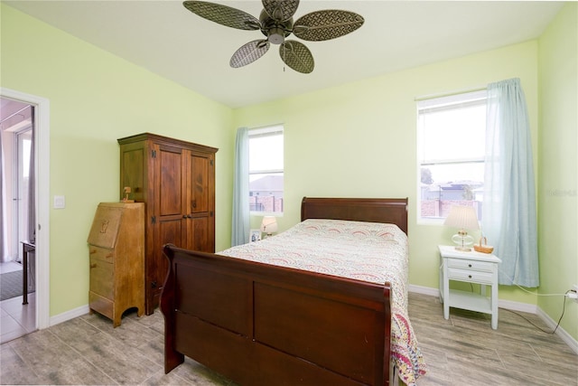 bedroom with light hardwood / wood-style flooring and ceiling fan