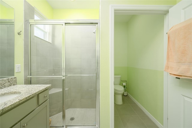 bathroom featuring a shower with shower door, tile patterned flooring, toilet, and vanity