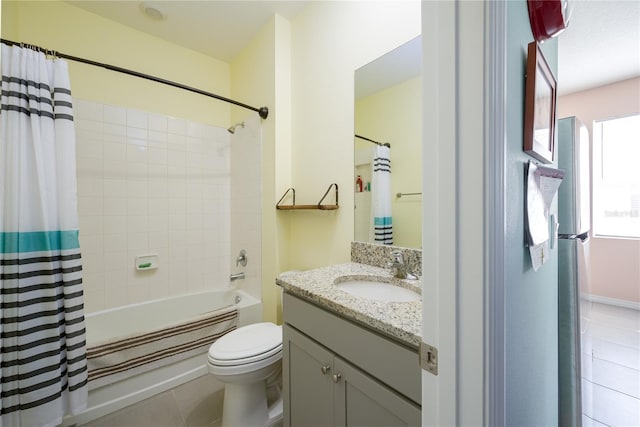 full bathroom featuring tile patterned flooring, vanity, toilet, and shower / tub combo