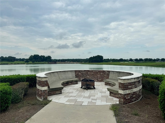 view of patio featuring a water view and an outdoor fire pit