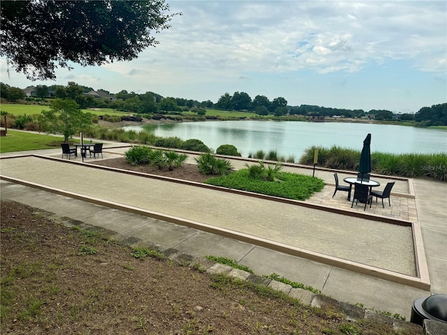 view of property's community with a patio and a water view