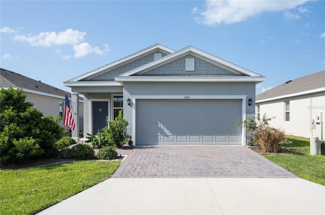 view of front facade featuring a garage and a front lawn