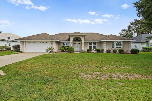 ranch-style home featuring a garage and a front yard