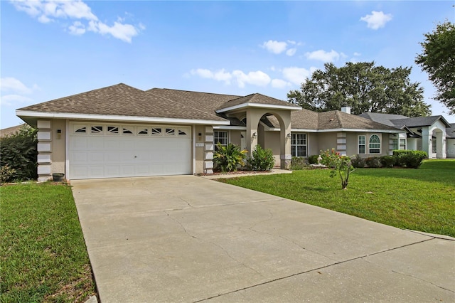 view of front of home featuring a front lawn and a garage