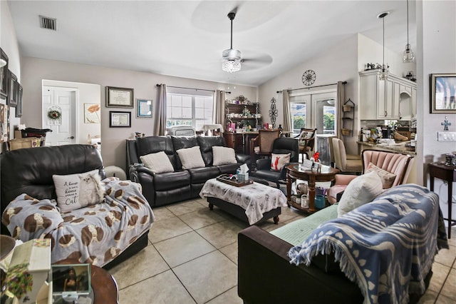 living room featuring lofted ceiling, plenty of natural light, ceiling fan, and light tile patterned flooring