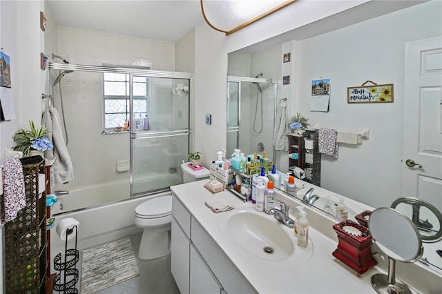 full bathroom featuring tile patterned flooring, vanity, toilet, and bath / shower combo with glass door