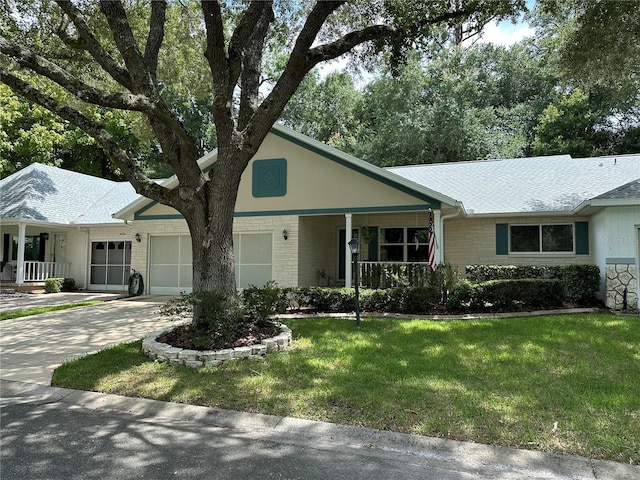 ranch-style house with covered porch, driveway, brick siding, and an attached garage