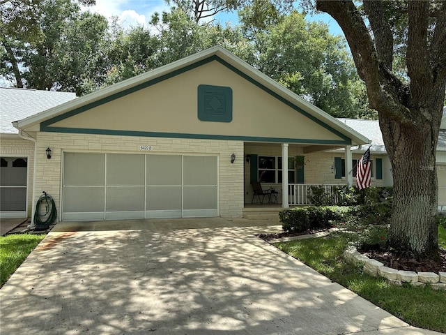 view of front facade featuring covered porch and a garage