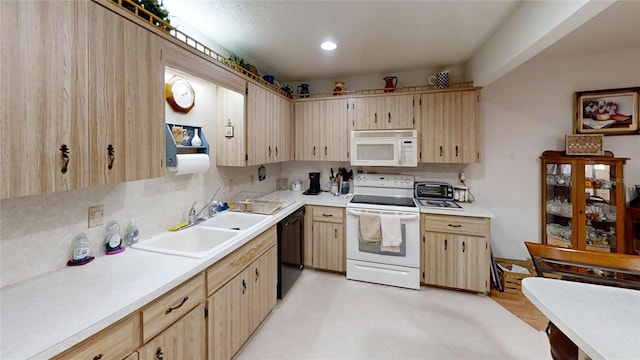 kitchen featuring light tile patterned flooring, white appliances, sink, and light brown cabinetry