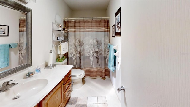 bathroom with toilet, vanity, and tile patterned flooring