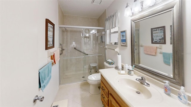 bathroom with a textured ceiling, a shower with door, toilet, tile patterned floors, and vanity