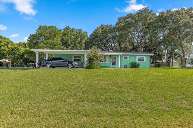 ranch-style home with a front yard and a carport