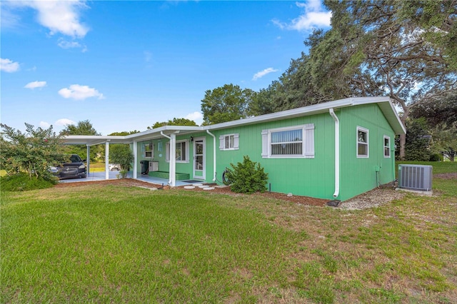 manufactured / mobile home with a front lawn and central AC unit