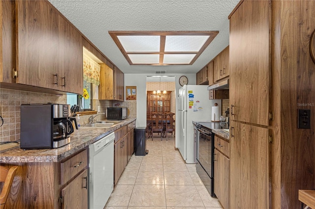 kitchen with black appliances, backsplash, a textured ceiling, and light tile patterned flooring