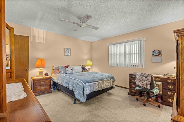 bedroom with ceiling fan, a textured ceiling, and light carpet