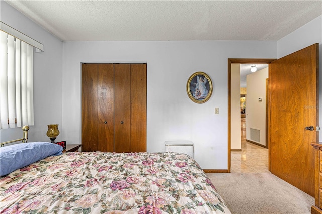 tiled bedroom featuring a textured ceiling and a closet