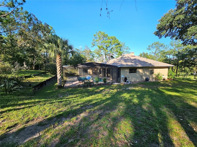 rear view of property featuring a yard