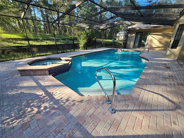 view of pool with glass enclosure, a patio, and an in ground hot tub