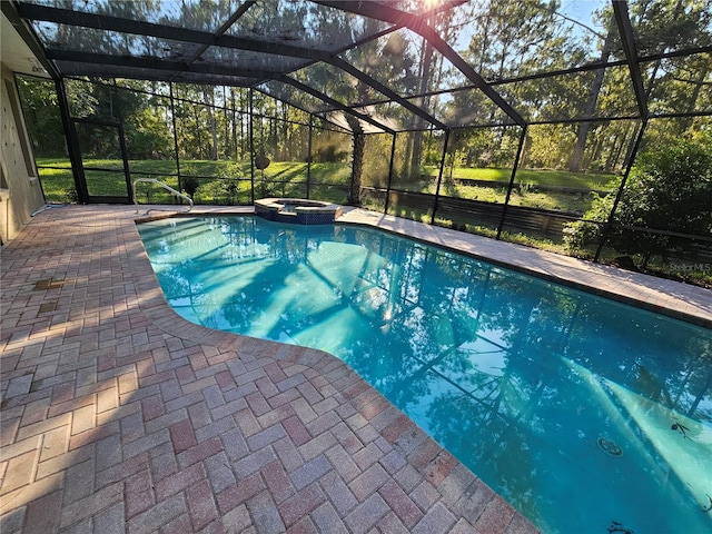 view of swimming pool featuring a patio, an in ground hot tub, and a lanai