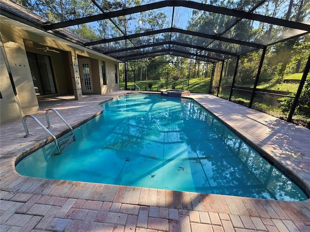 view of pool featuring glass enclosure and a patio area