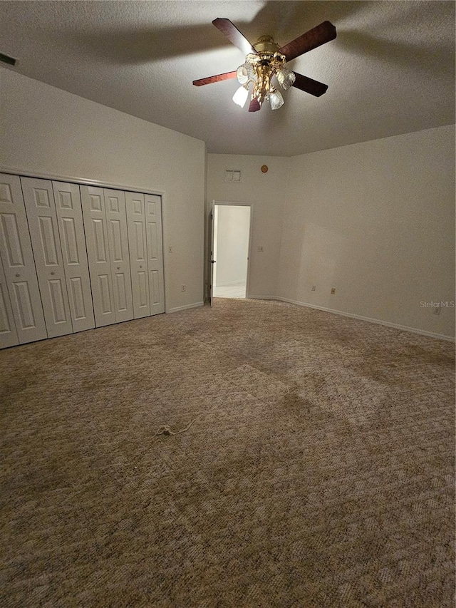 unfurnished bedroom featuring ceiling fan, a closet, and carpet