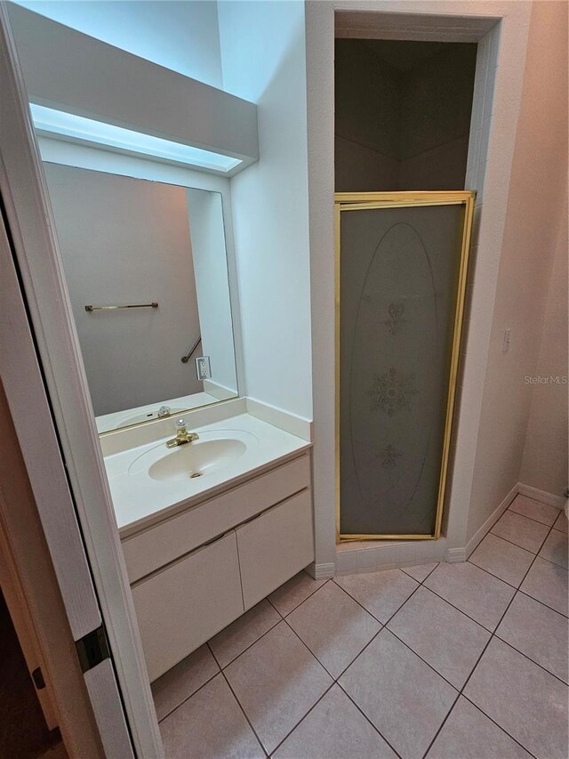 bathroom with vanity, tile patterned flooring, and an enclosed shower