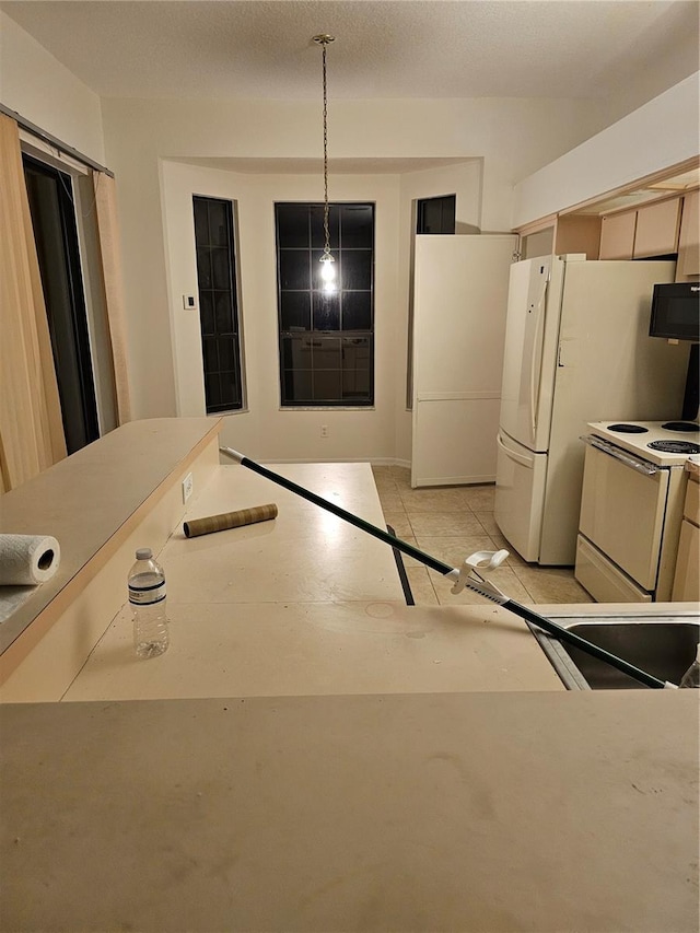 kitchen featuring white appliances and decorative light fixtures