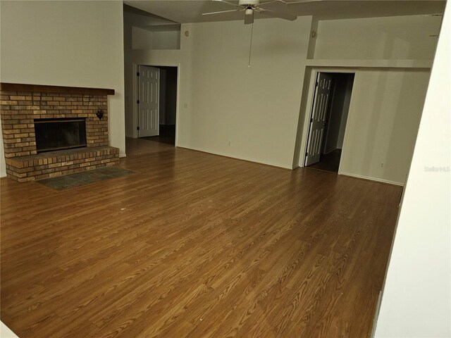 unfurnished living room with ceiling fan, wood-type flooring, and a fireplace