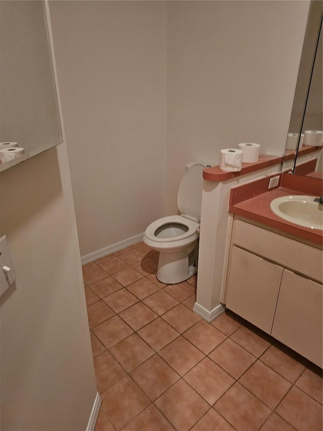 bathroom with vanity, toilet, and tile patterned flooring