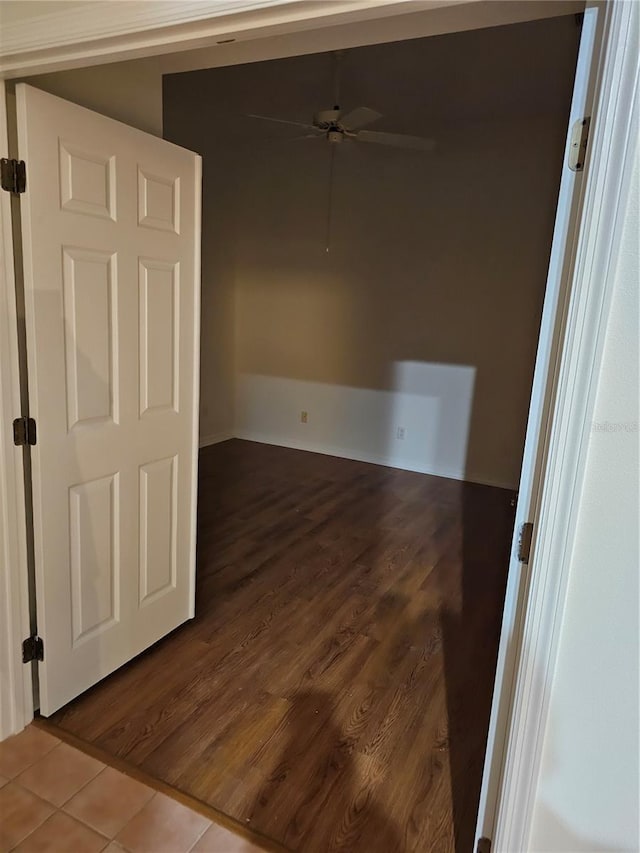 spare room with ceiling fan and wood-type flooring