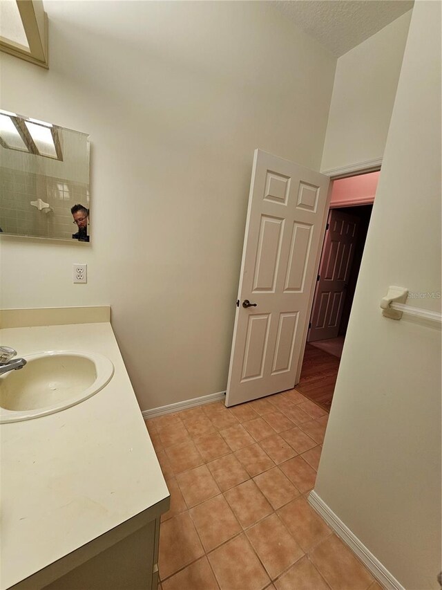 bathroom with tile patterned floors and vanity