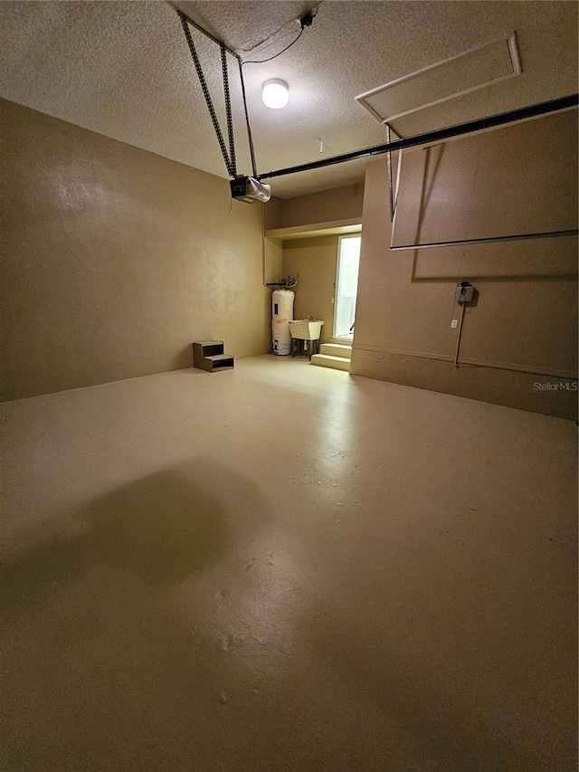 interior space featuring a garage door opener, sink, and gas water heater