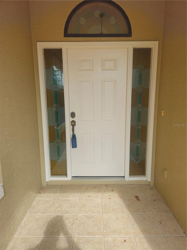 doorway to property with stucco siding