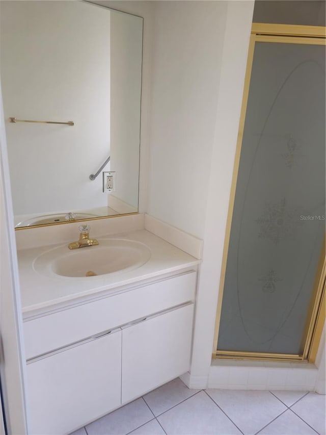 bathroom with a shower stall, vanity, and tile patterned floors