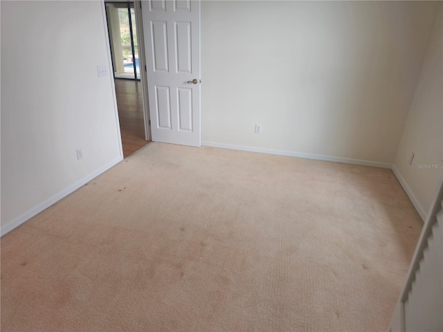 carpeted spare room with baseboards