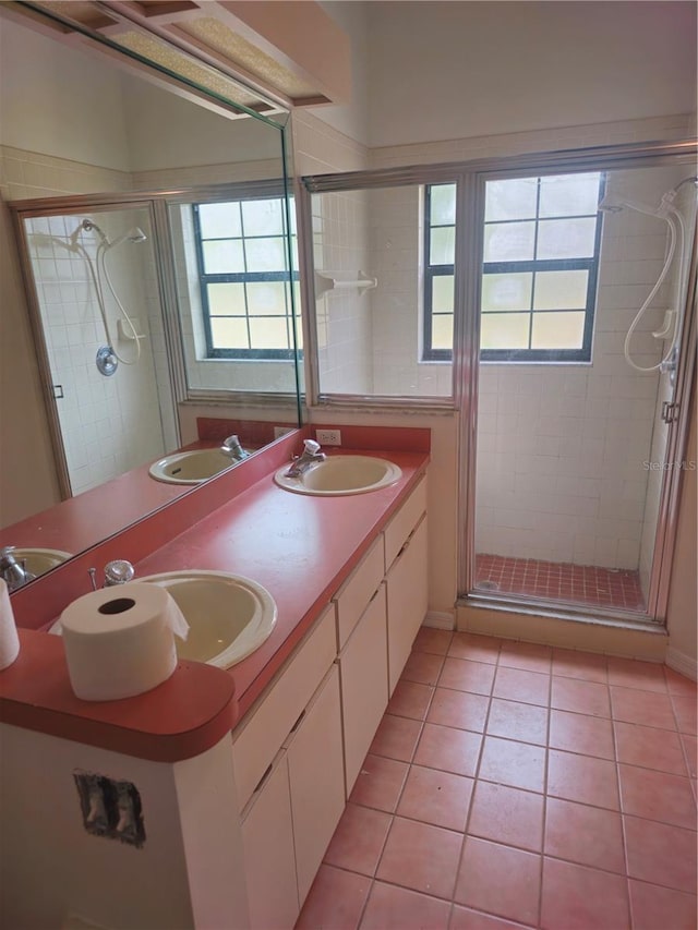 full bathroom with tile patterned flooring, a sink, and a shower stall