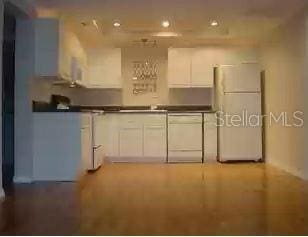 kitchen with white appliances and white cabinets