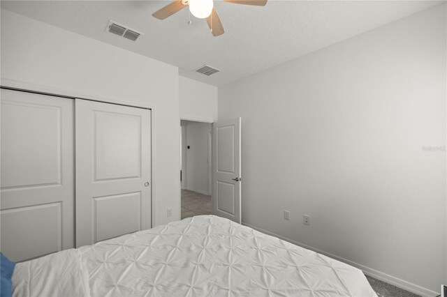 bedroom featuring ceiling fan, a closet, and carpet floors