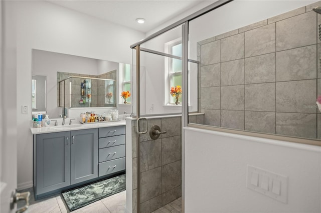 bathroom featuring tile patterned flooring, an enclosed shower, a healthy amount of sunlight, and vanity