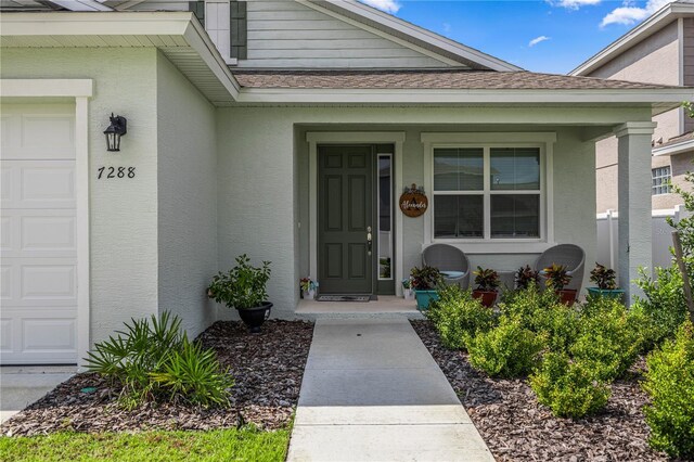 doorway to property with a garage