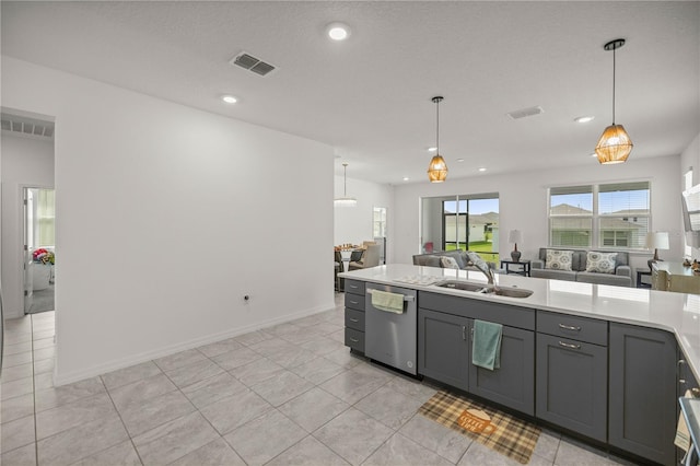 kitchen featuring light tile patterned flooring, sink, decorative light fixtures, and dishwasher