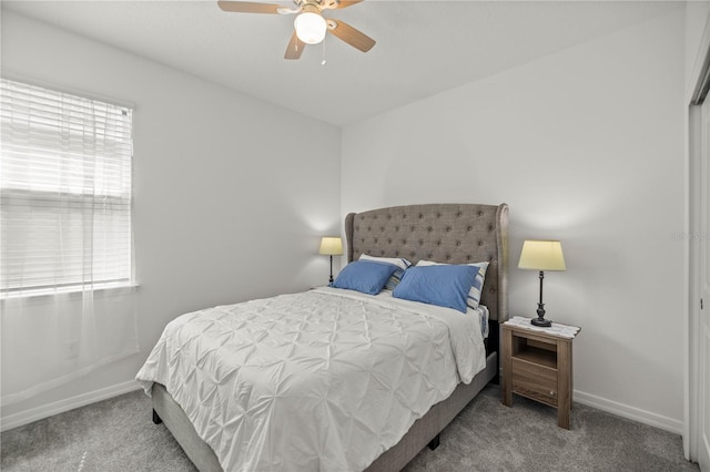 bedroom featuring ceiling fan, multiple windows, and light colored carpet