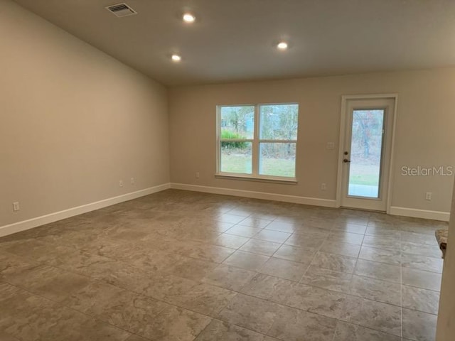 spare room with recessed lighting, visible vents, and baseboards