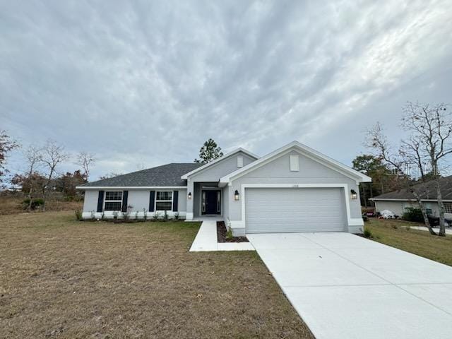 ranch-style home with a front yard and a garage