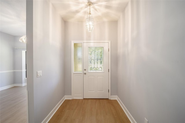 interior space with an inviting chandelier and light hardwood / wood-style floors