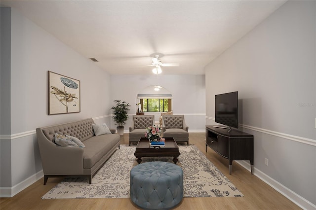 living room with ceiling fan and hardwood / wood-style flooring