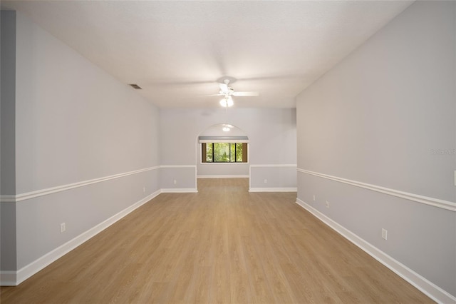 empty room with ceiling fan and light hardwood / wood-style floors