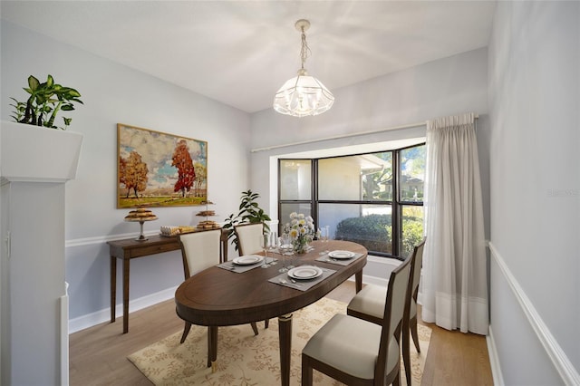 dining space featuring a chandelier and light hardwood / wood-style floors