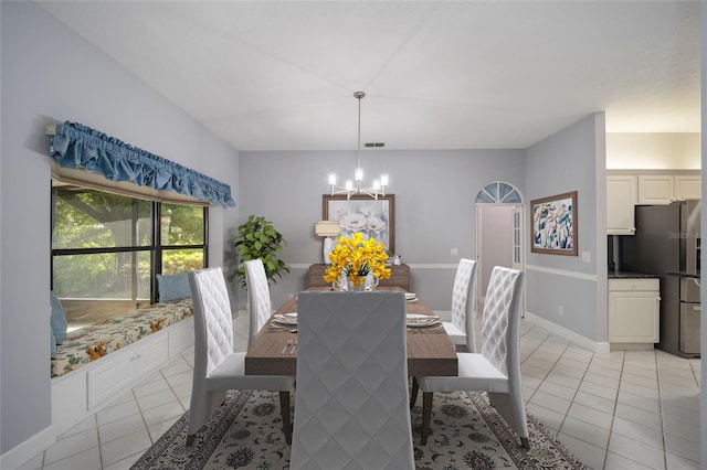 dining area with an inviting chandelier and light tile patterned floors