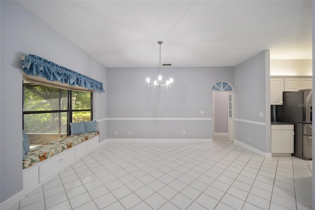 unfurnished dining area featuring a chandelier and light tile patterned flooring